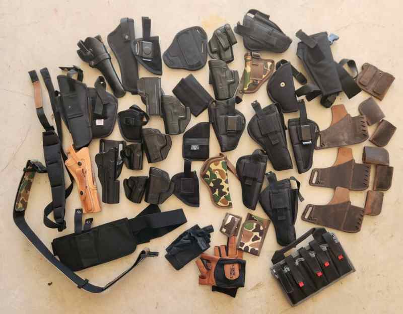 Box of 30+ holsters, pouches, sling, belt, gloves